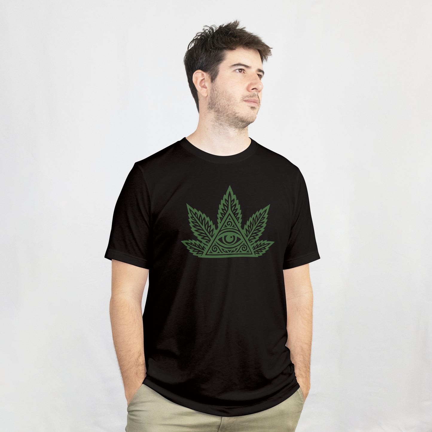 Person wearing a black t-shirt with a green cannabis leaf design on a white background