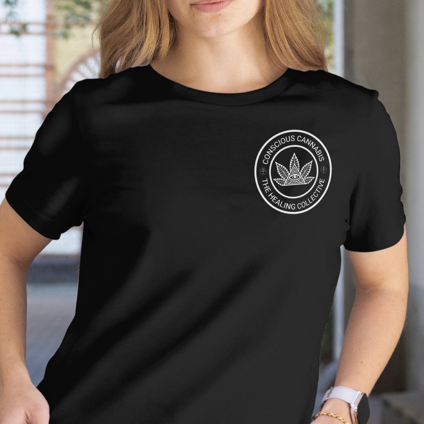 Woman wearing a black t-shirt with a logo in an indoor setting