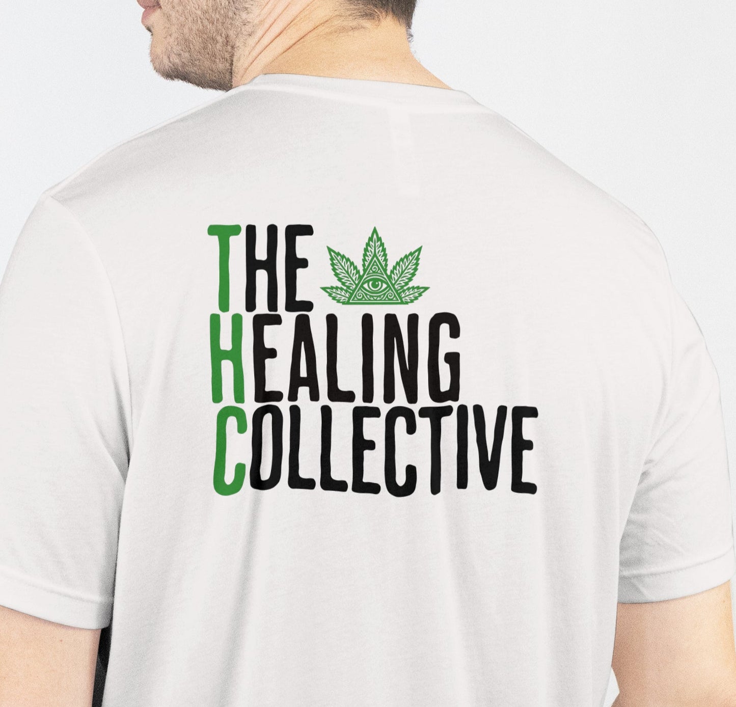 Person wearing a white t-shirt with 'The Healing Collective' text and logo on the back.