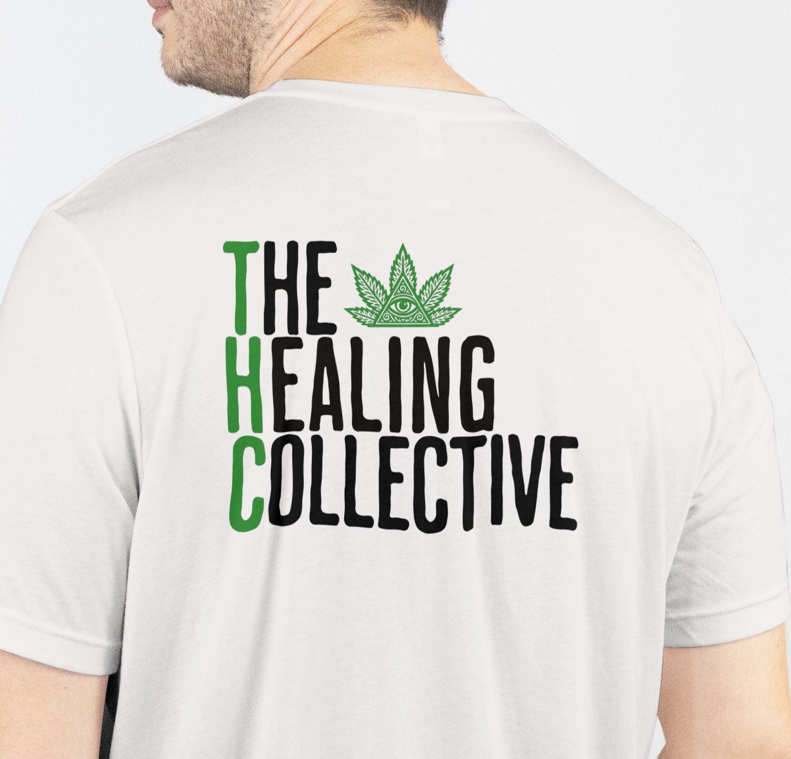Person wearing a white t-shirt with 'The Healing Collective' text and logo on the back.