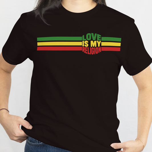 Person wearing a black t-shirt with 'Love is my Religion' text in Rastafarian colors on a white background