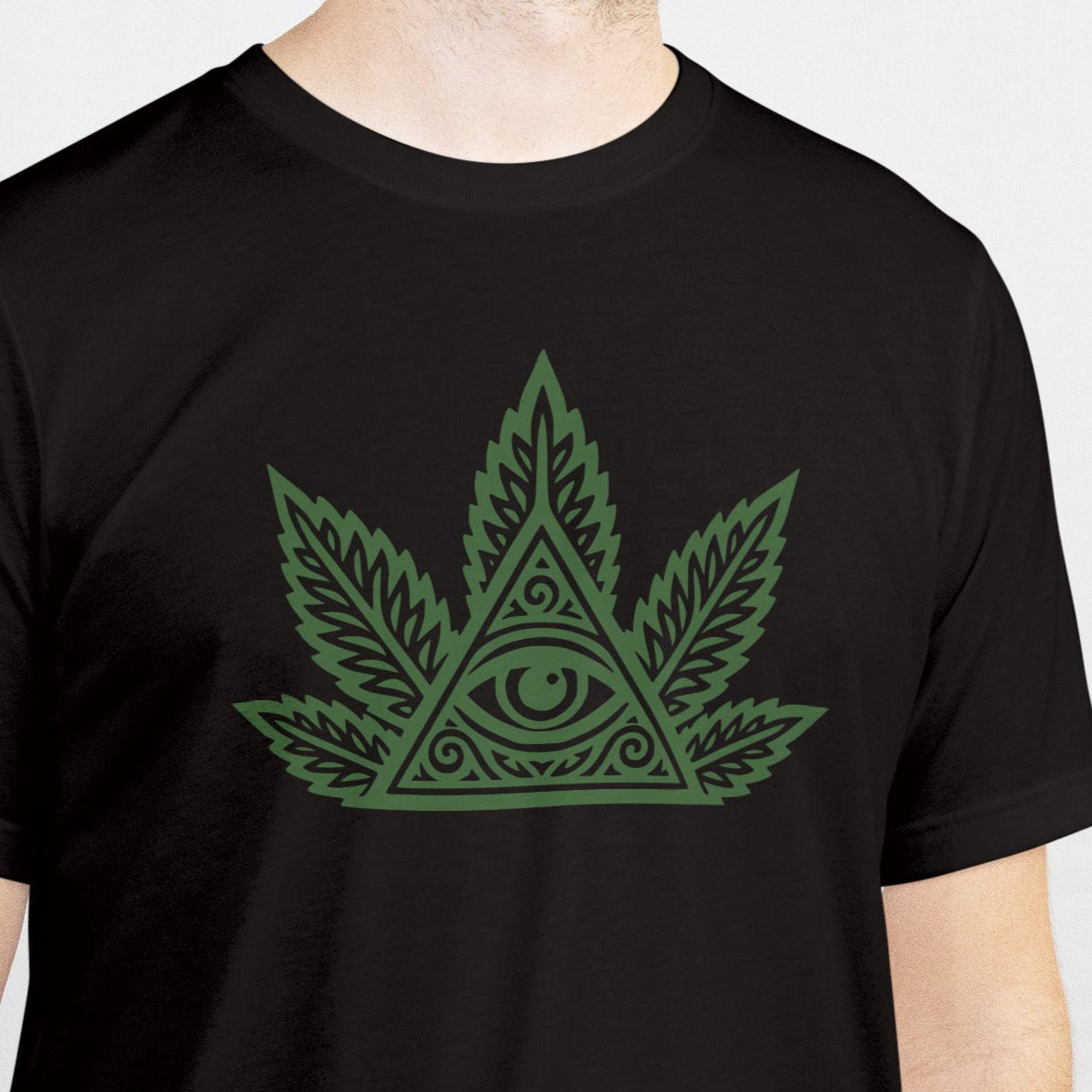 Person wearing a black t-shirt with a green cannabis leaf design on a white background