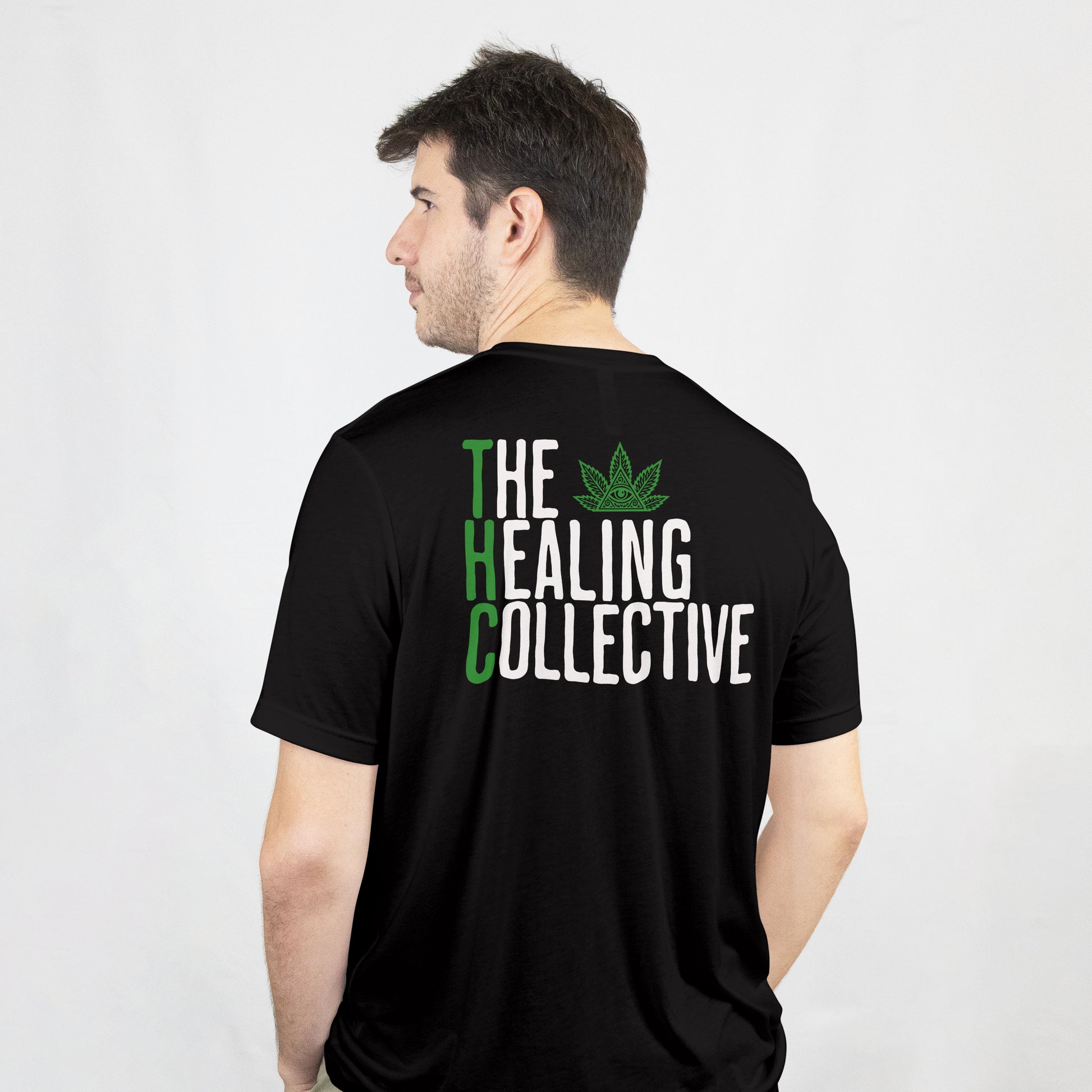 Person wearing a black t-shirt with 'The Healing Collective' text and logo on the back.