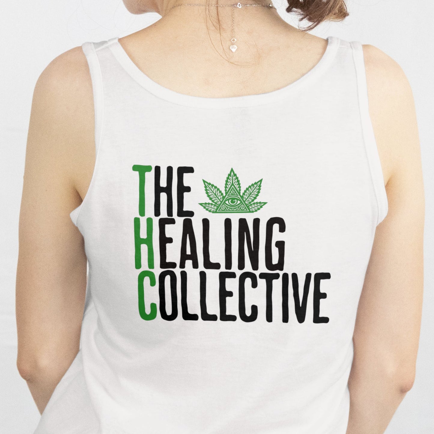 Person wearing a white tank top with 'The Healing Collective' text and logo on a plain background