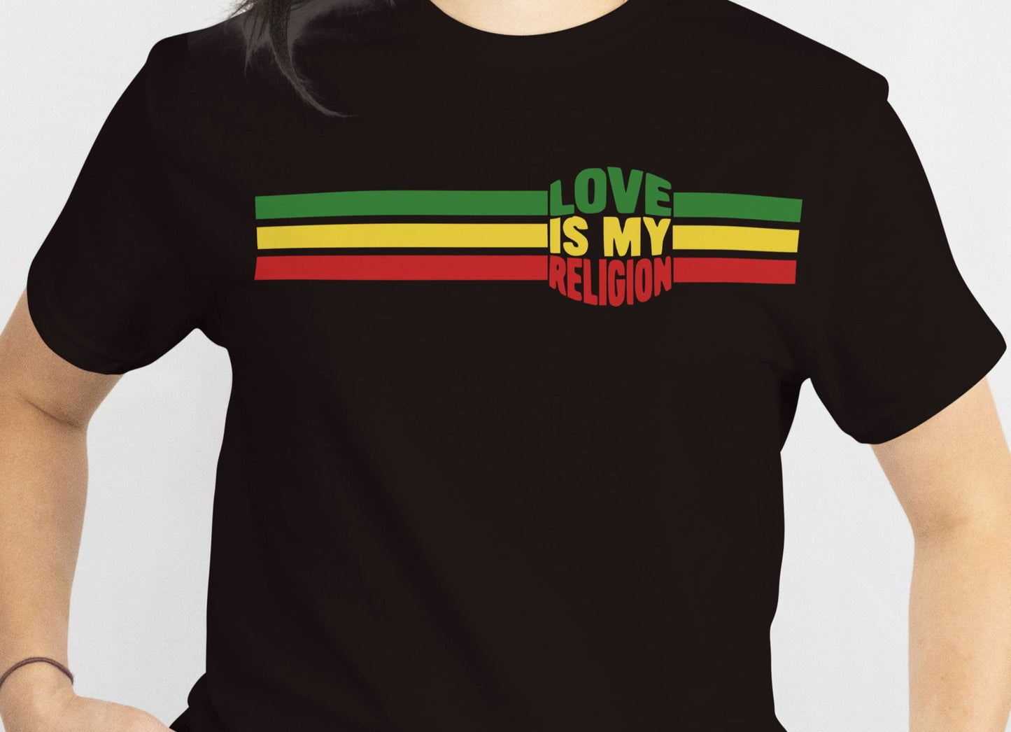 Black t-shirt with 'Love is My Religion' text in Rastafarian colors on a plain background