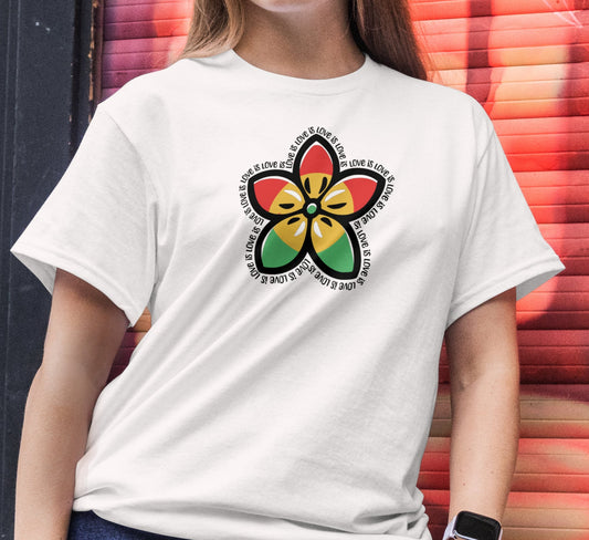 Person wearing a white t-shirt with a colorful flower design in front of a vibrant graffiti wall.