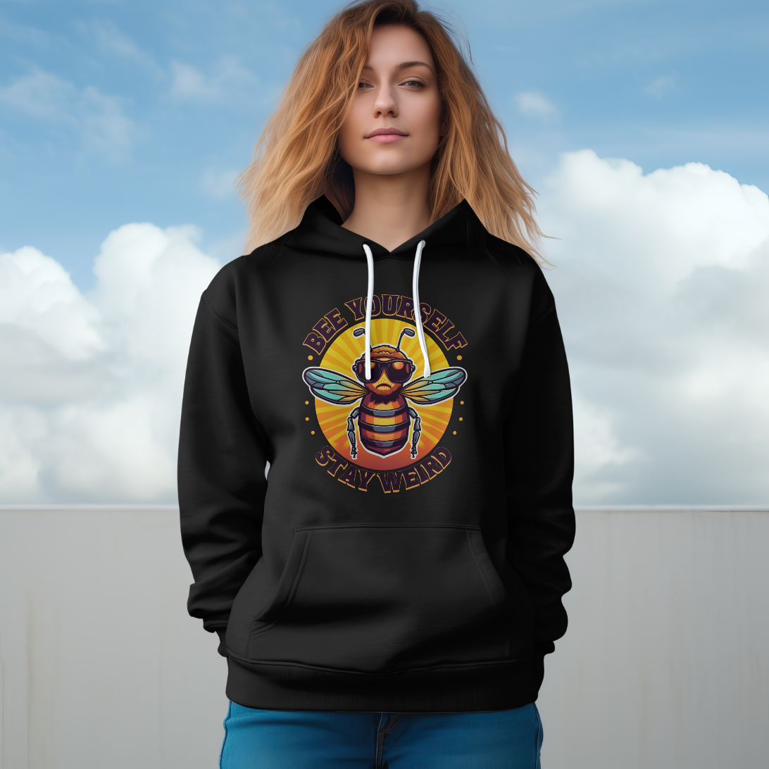 Person wearing a black hoodie with a bee graphic against a cloudy sky