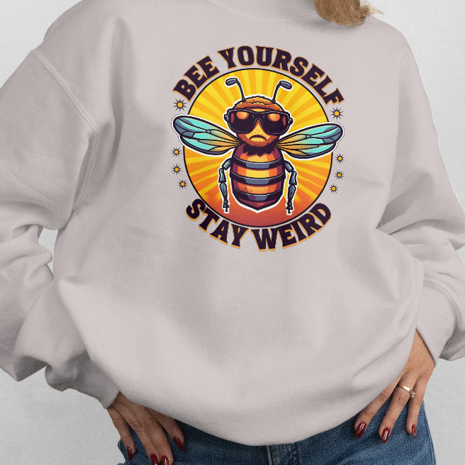 Person wearing a light gray sweatshirt with a bee graphic and text on a white background