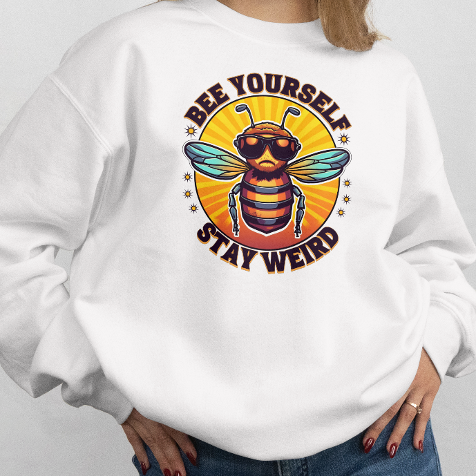 Person wearing a white sweatshirt with a bee graphic and text on a plain background