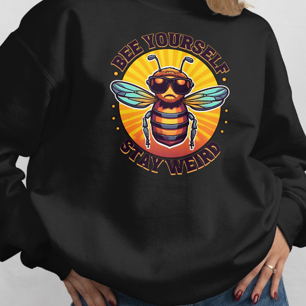 Person wearing a black sweatshirt with a bee graphic and text on a plain background