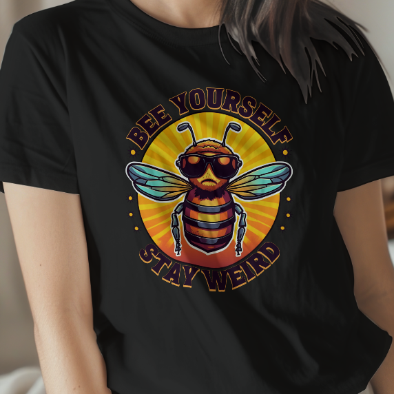Woman wearing a black t-shirt with a colorful bee graphic and text in a bedroom setting