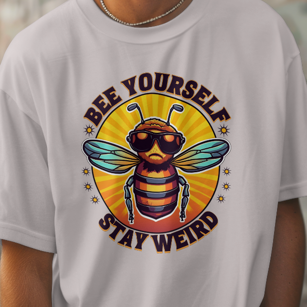 Person wearing a Heather gray t-shirt with a bee graphic and text in an urban setting