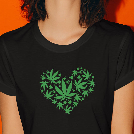 Woman wearing a black t-shirt with green leaf design on an orange background