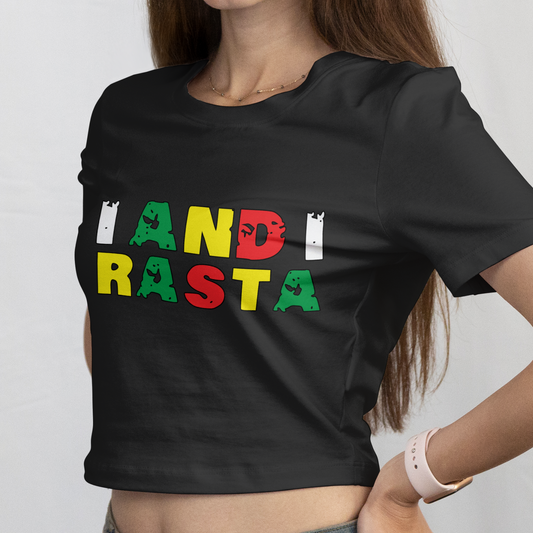 Woman wearing a black t-shirt with 'I AND RASTA' text in colorful letters on a plain background