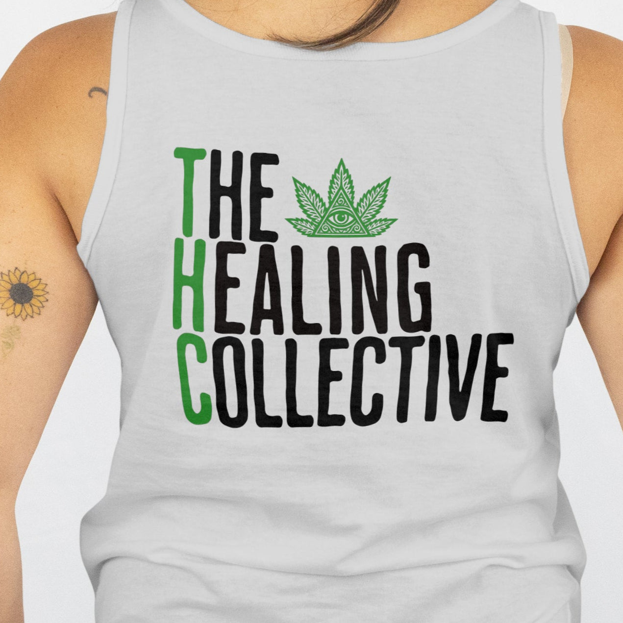 Person wearing a tank top with 'The Healing Collective' logo on the back.