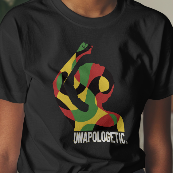 Person wearing a black t-shirt with a colorful design and text in a room with plants and furniture.